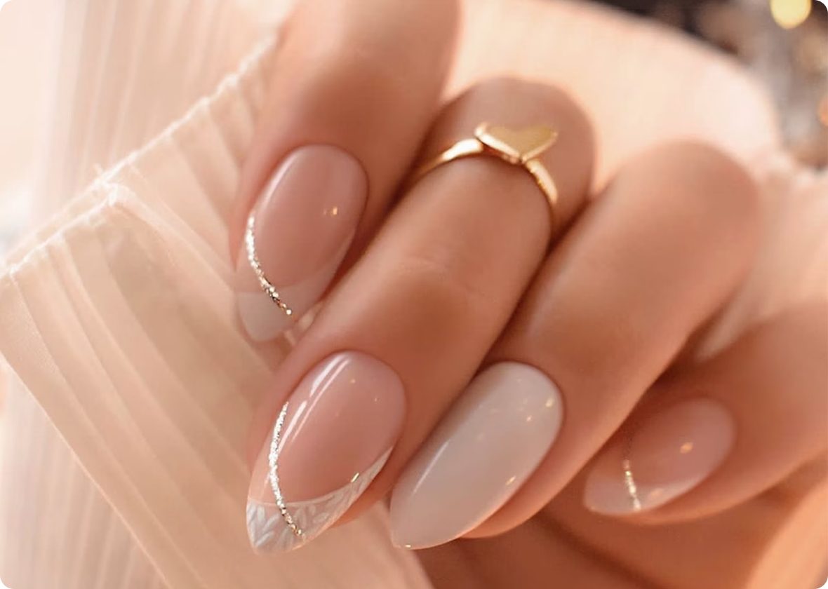 Almond nails in soft nude with glitter French tips